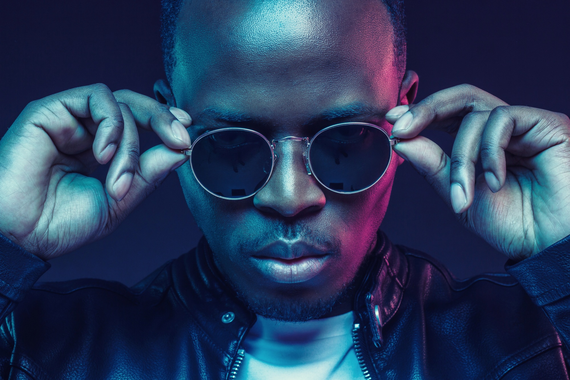 African american male model wearing trendy sunglasses and leather jacket