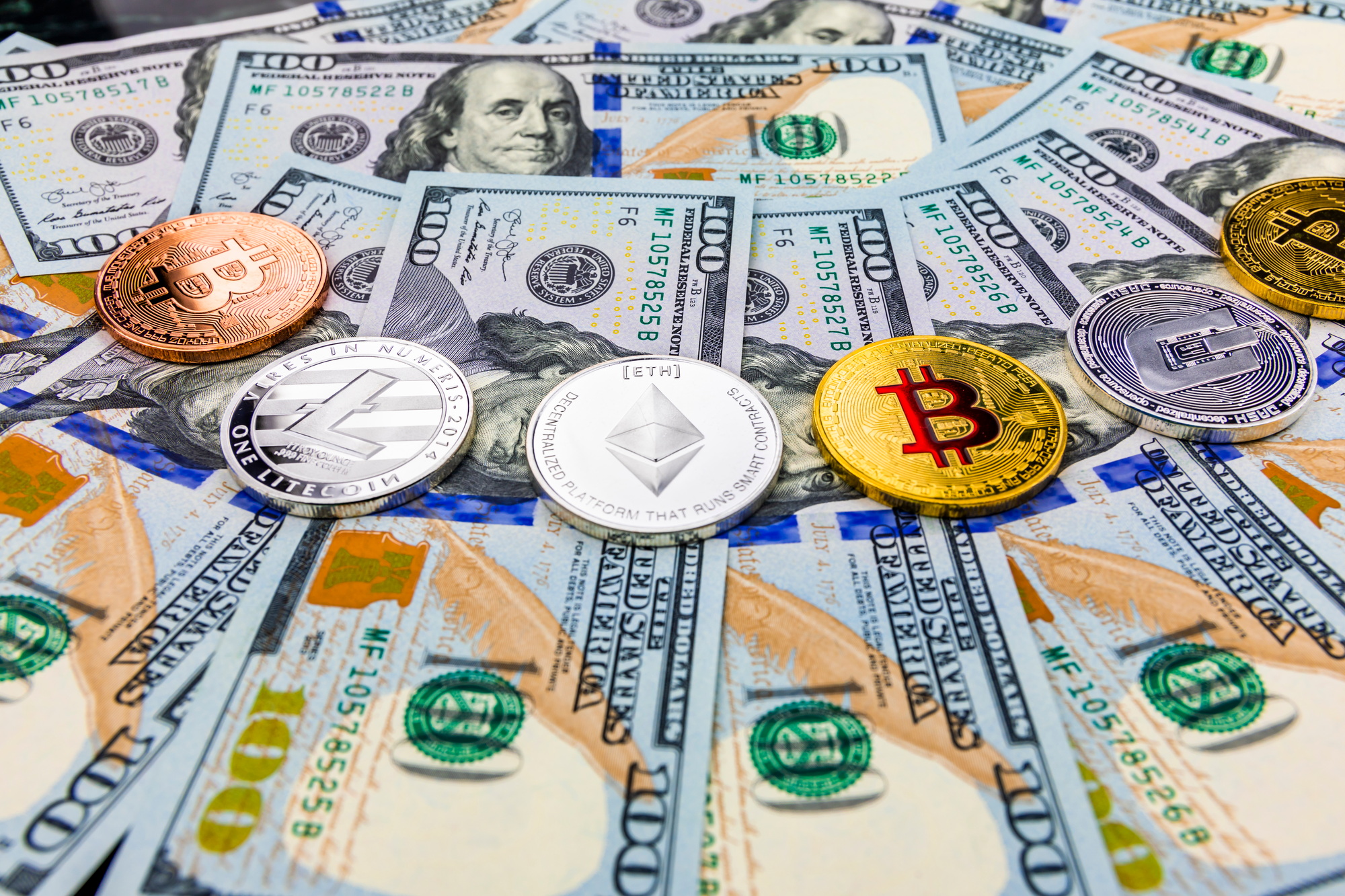 Bitcoin and cryptocurrency on banknotes of one hundred dollars